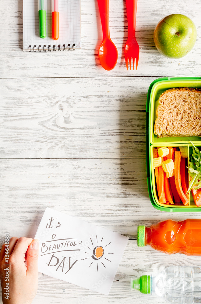 kid menu lunchbox for school top view on wooden background