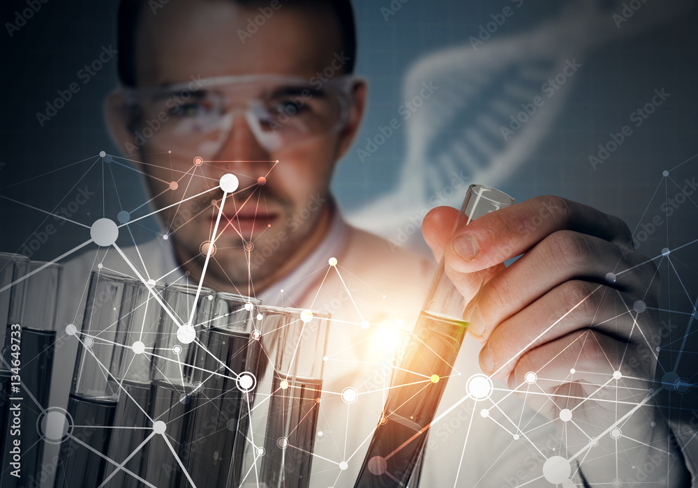 Portrait of concentrated male scientist working with reagents in laboratory