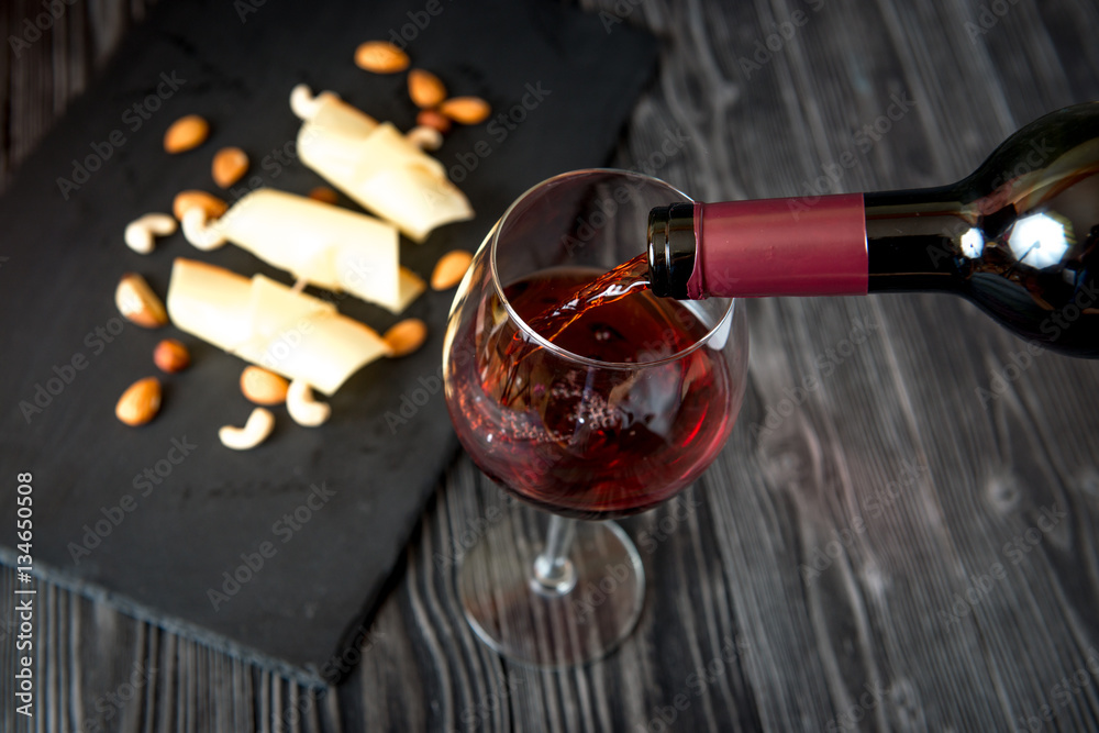 red wine with cheese on wooden background top view