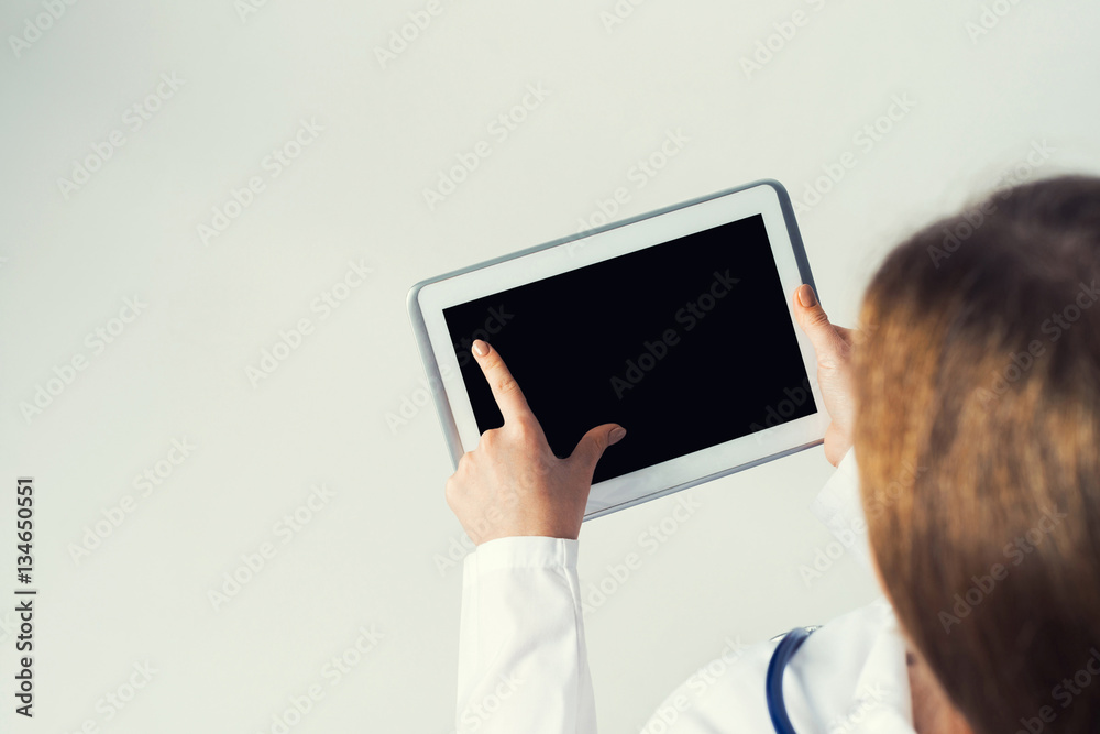 Close of female doctor hands working with tablet pc computer