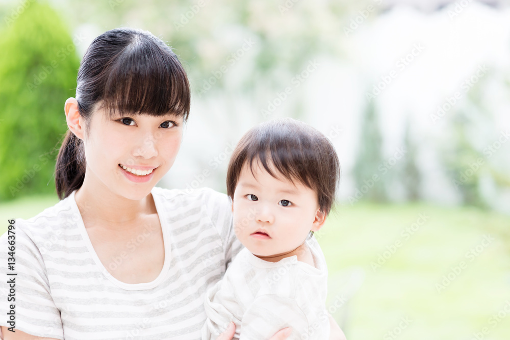 portrait of asian mother and baby in the park