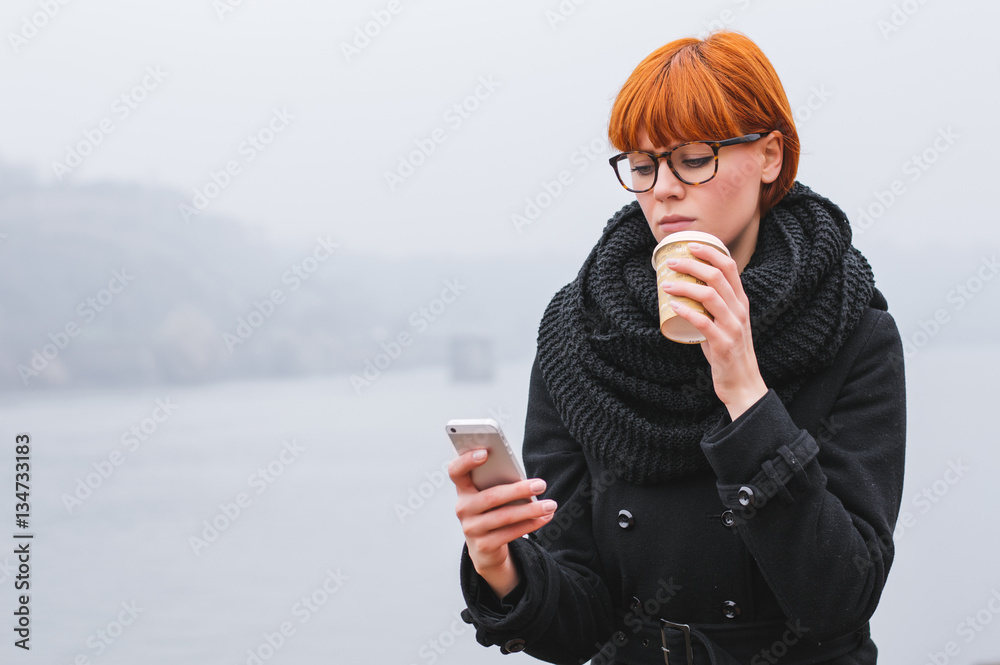 Woman texting while relaxing outside