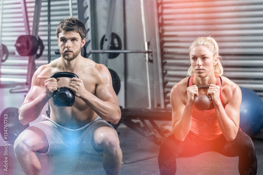 Couple lifting dumbbells together