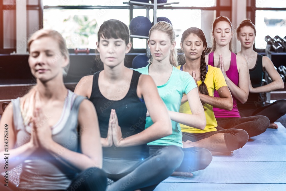 Fitness class doing yoga exercises