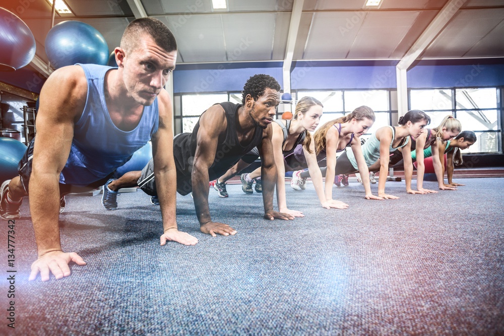 Fit people working out in fitness class