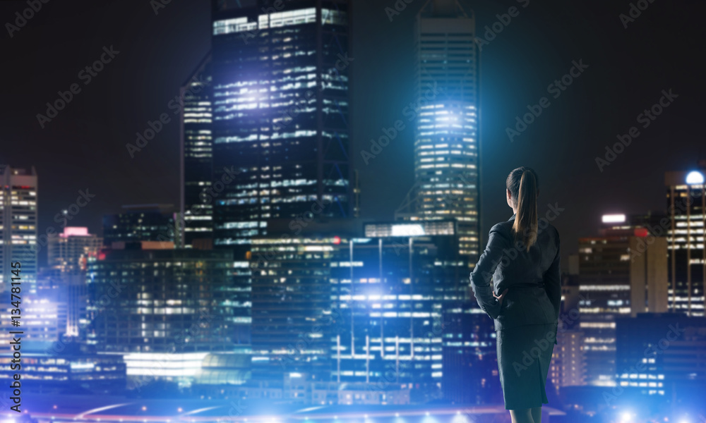 Woman looking at night city