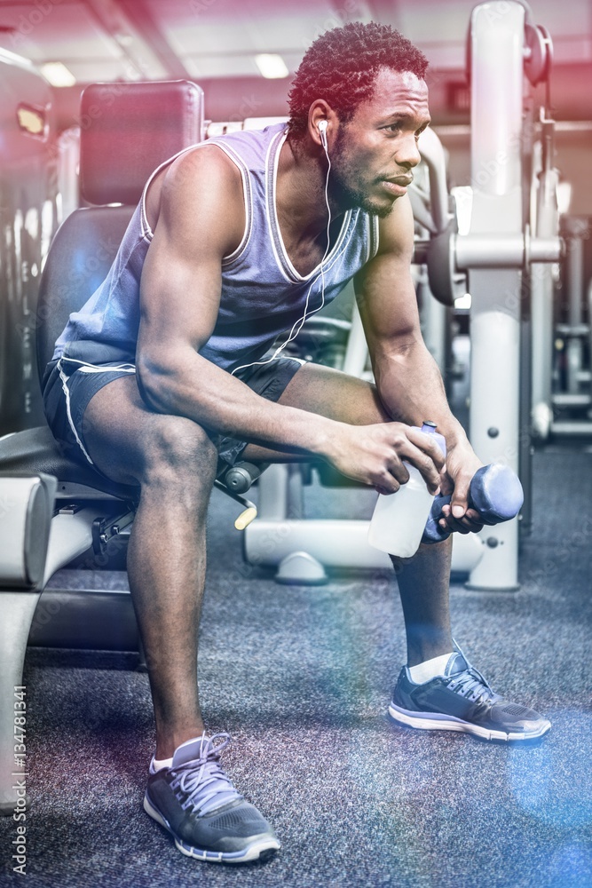 Thoughtful muscular man taking break