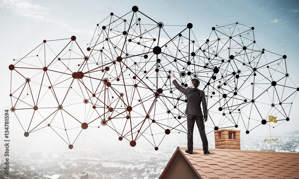 Businessman on house roof presenting networking and connection c