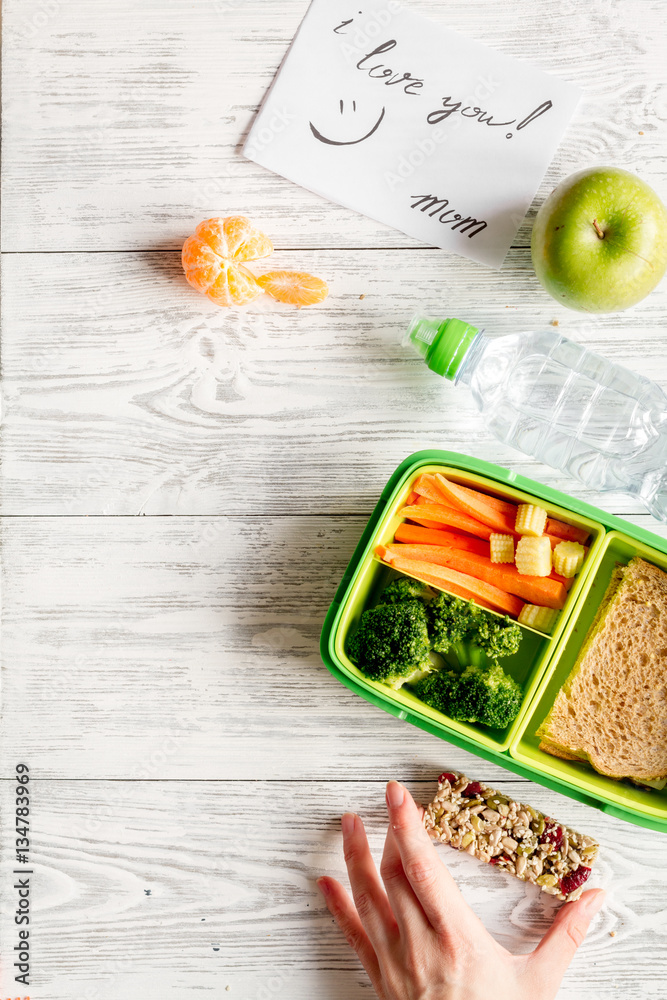 kid menu lunchbox for school top view on wooden background