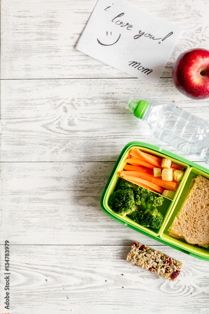 kid menu lunchbox for school top view on wooden background