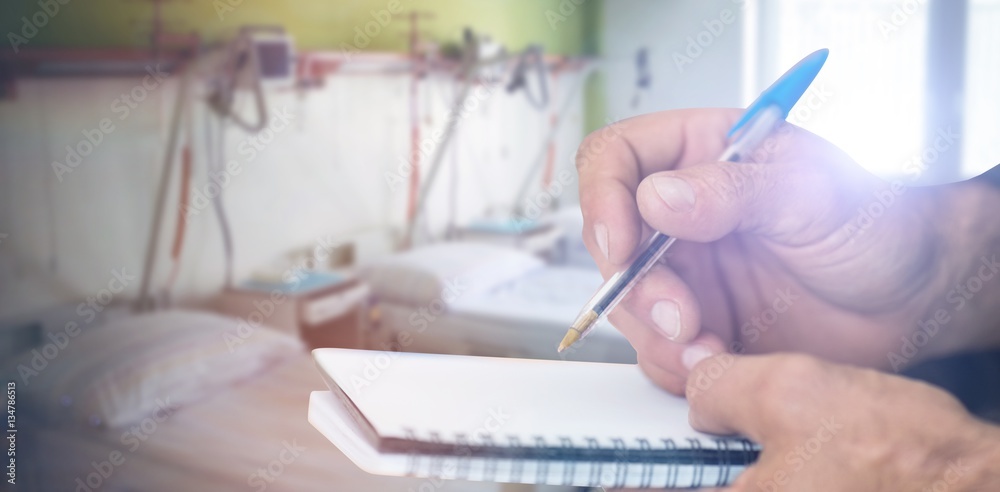 Composite image of close up of man writing in notepad