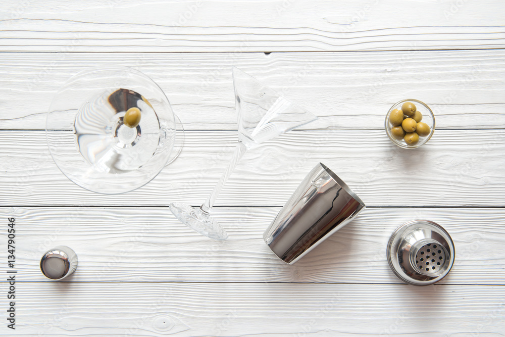 martini and shaker top view of wooden background