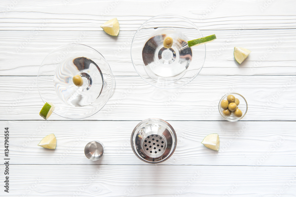 martini and shaker top view of wooden background