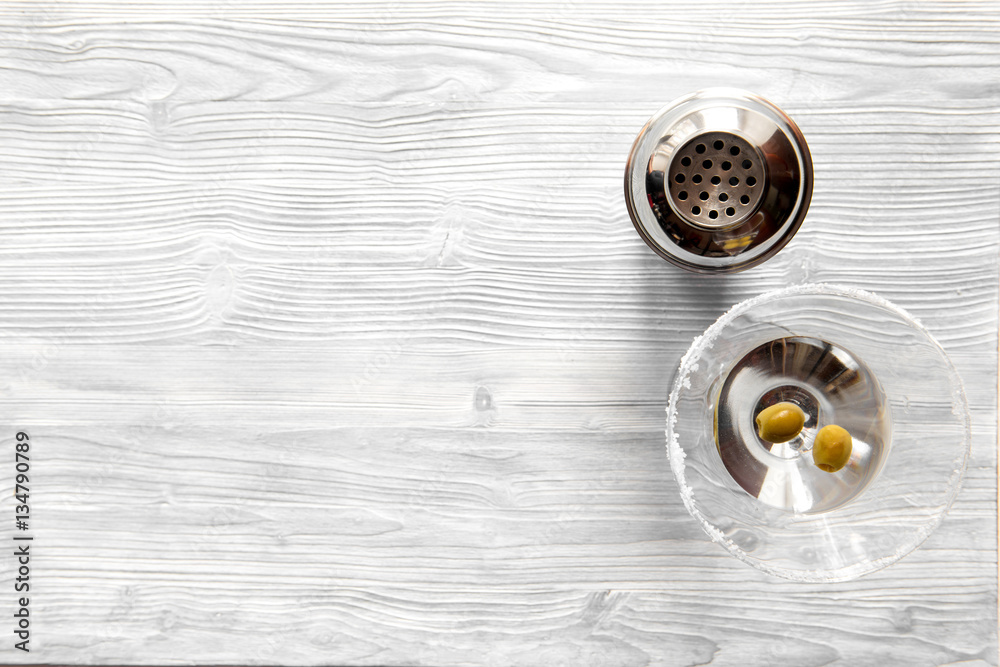 martini and shaker top view of wooden background