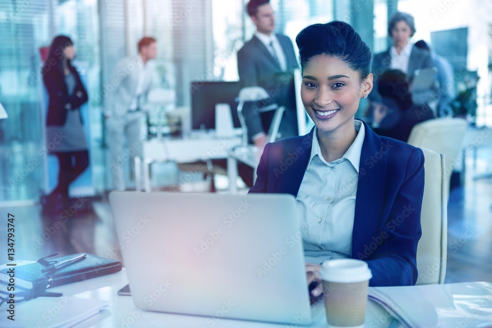 Businesswoman working on laptop in office