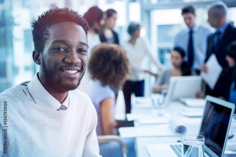 Smiling businessman sitting in office