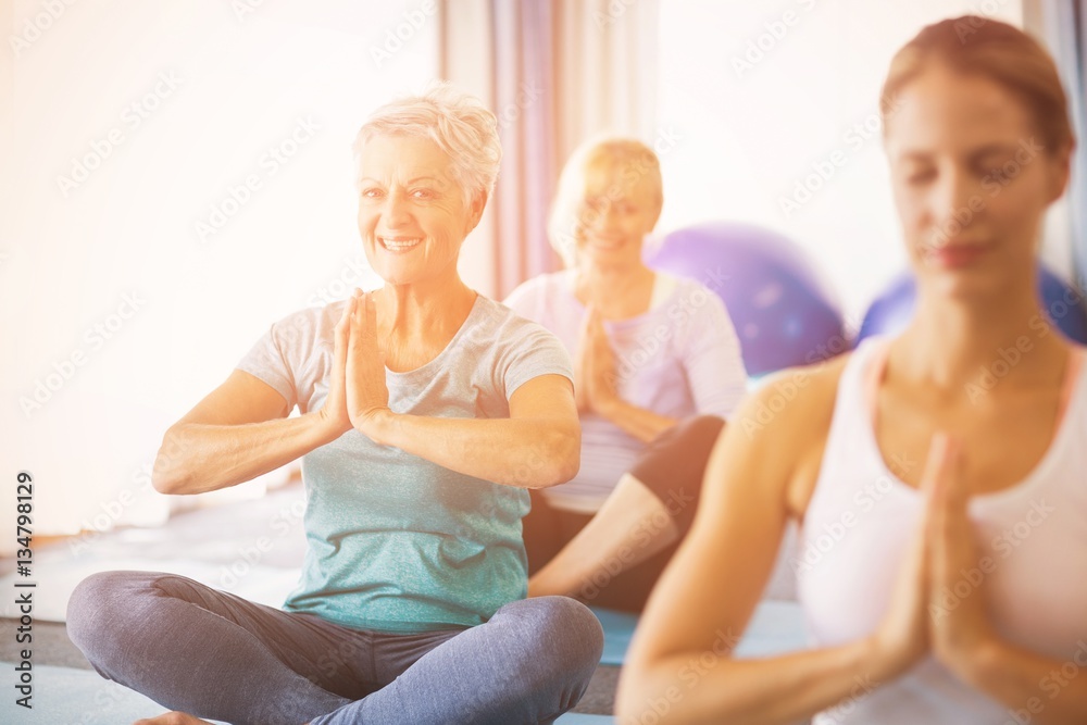 Instructor performing yoga with seniors