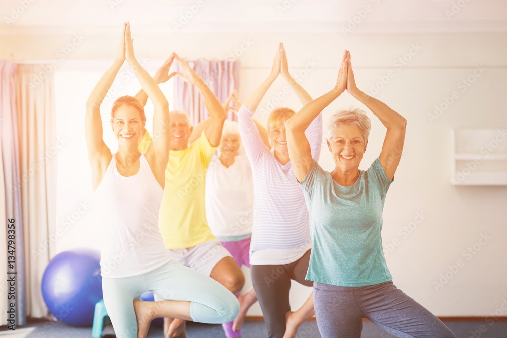 Instructor performing yoga with seniors