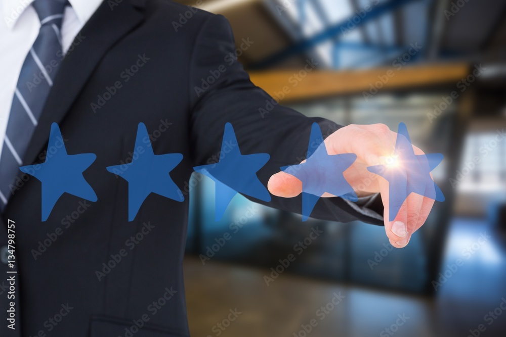 Composite image of businessman in suit pointing his finger