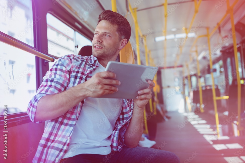 Low angle view of handsome man using digital tablet