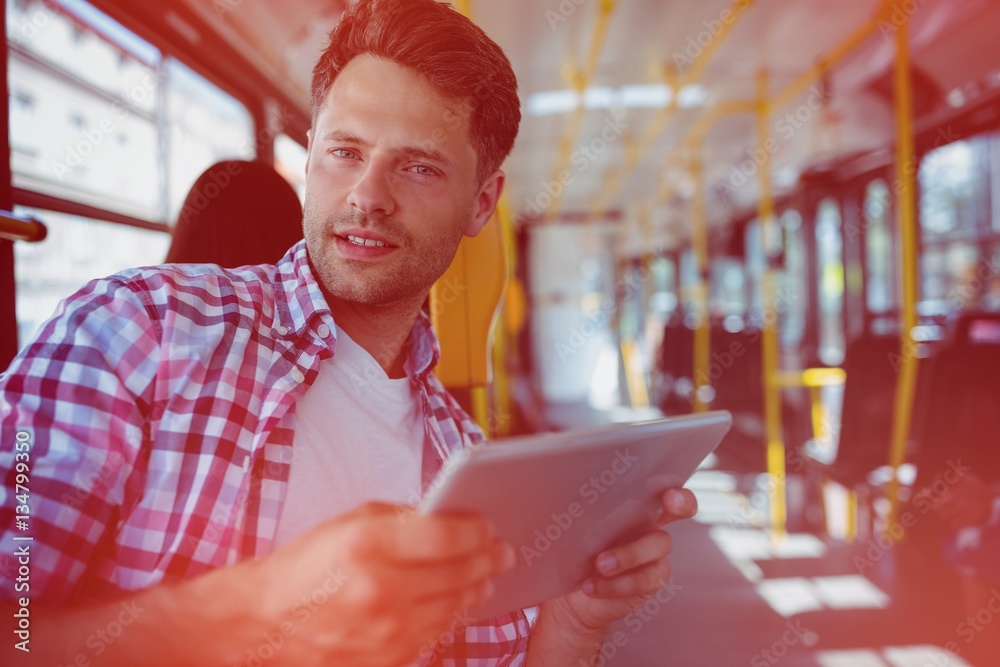 Portrait of handsome man holding digital tablet