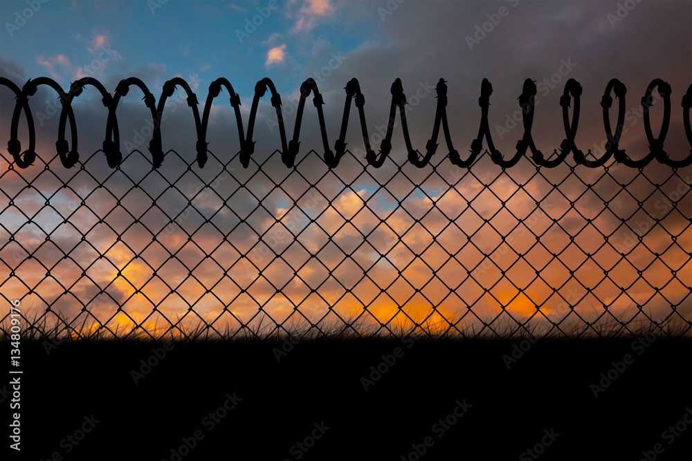 Composite image of barbed wire fence by white background