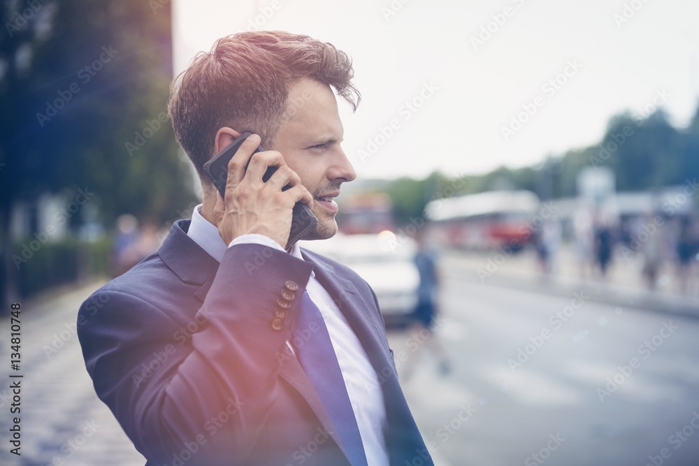 Handsome businessman speaking on mobile phone