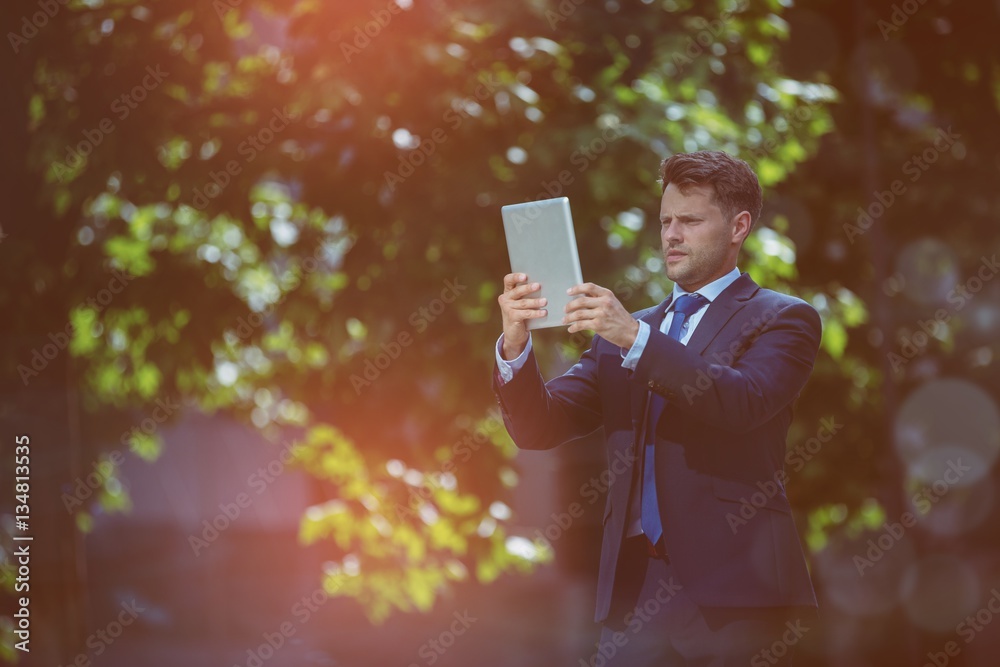 Low angle view of businessman using digital tablet