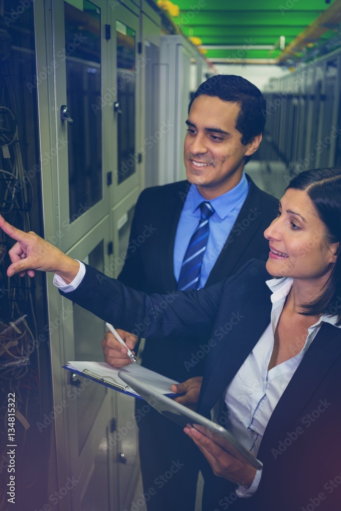 Technicians interacting with each other while analyzing server