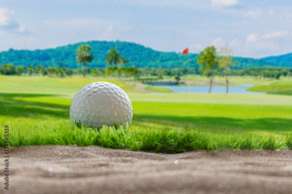 Golf ball on sand bunker in golf courses