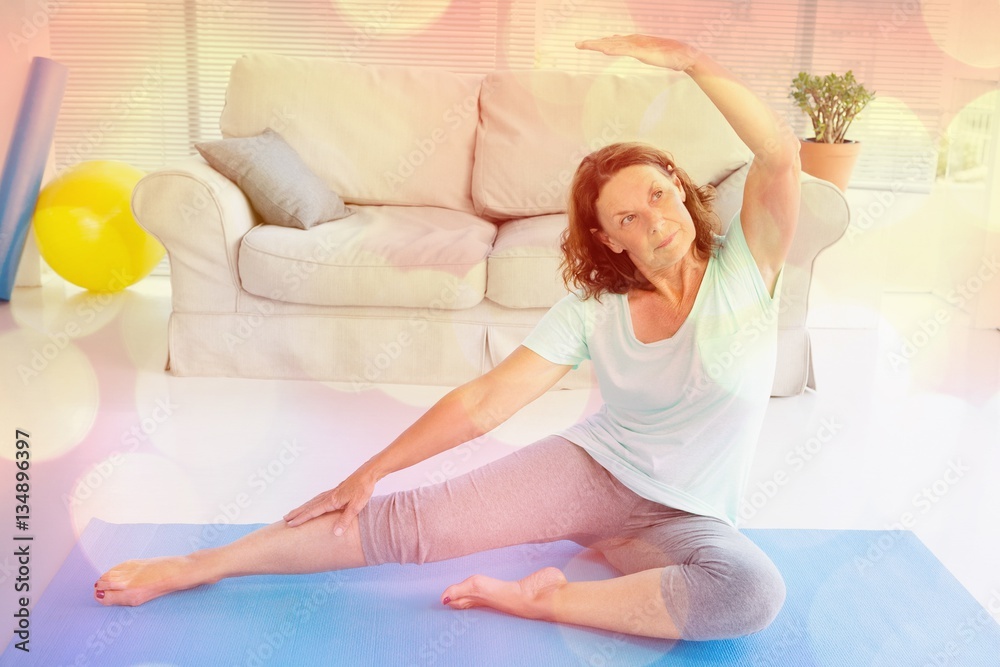 Mature woman stretching on exercise mat 