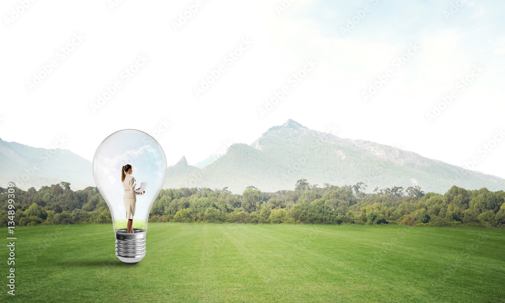 Businesswoman inside light bulb