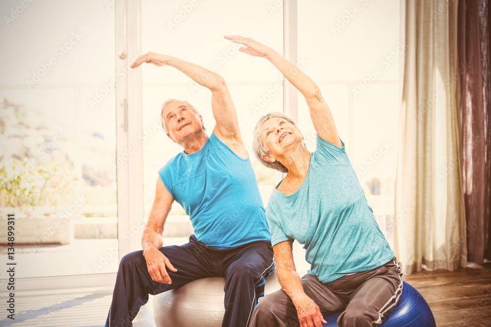 Senior couple exercising at home