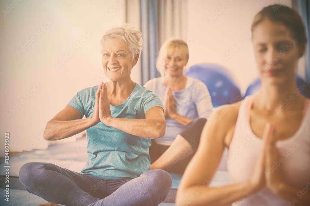 Instructor performing yoga with seniors