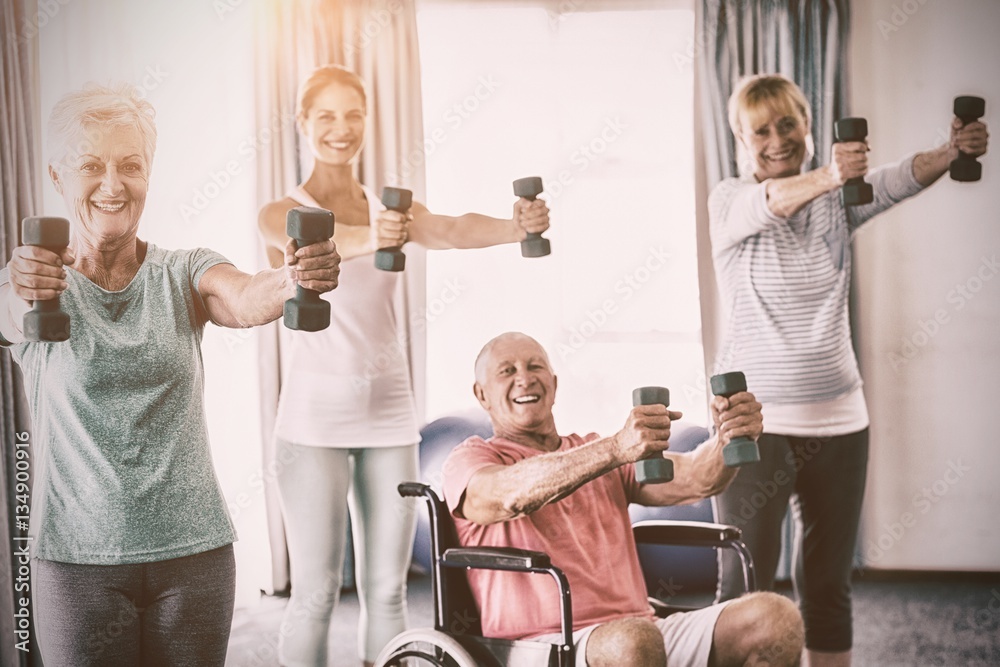 Portrait of seniors exercising with weights