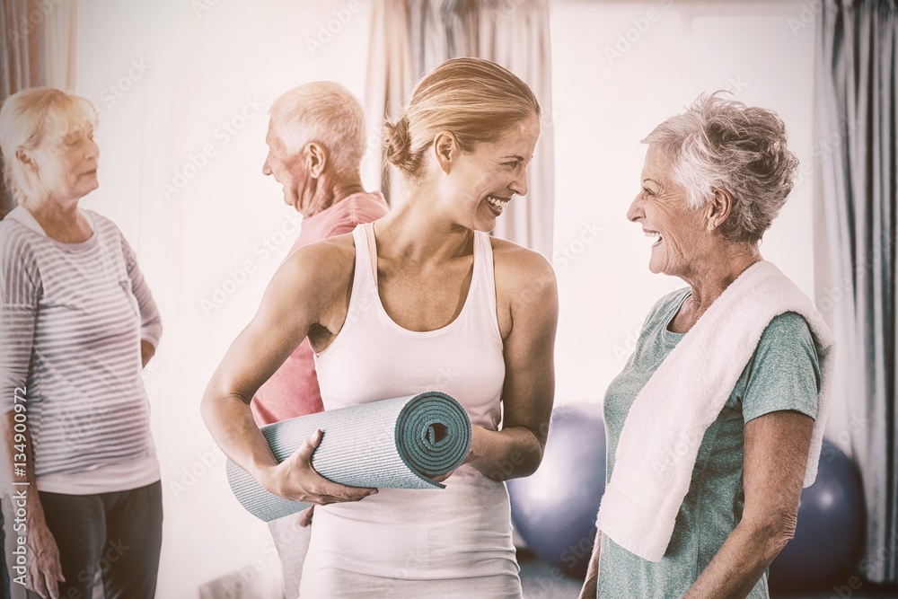 Instructor standing together with seniors