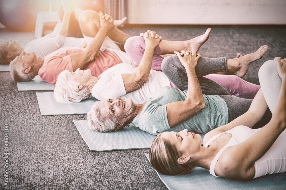 Instructor performing yoga with seniors