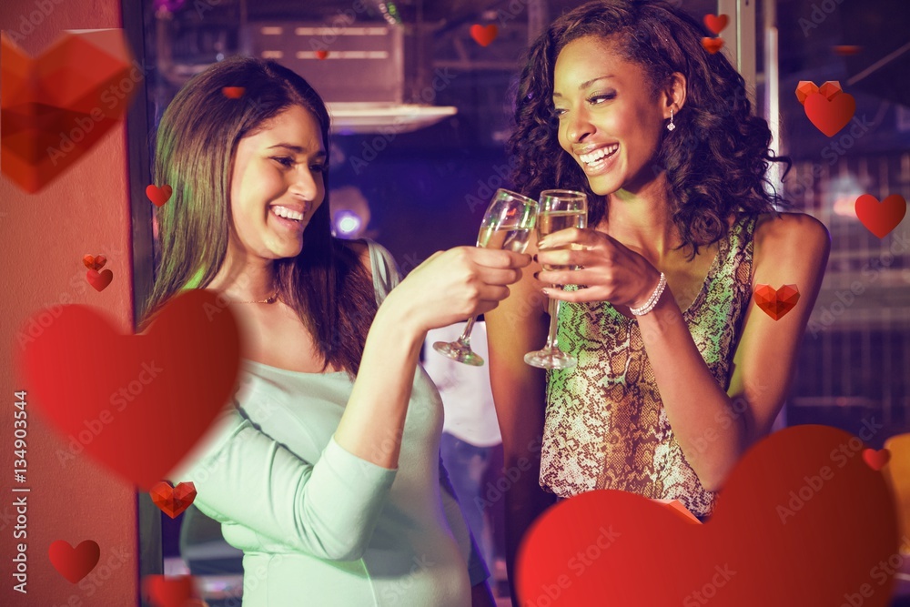 Composite image of happy women toasting champagne glasses