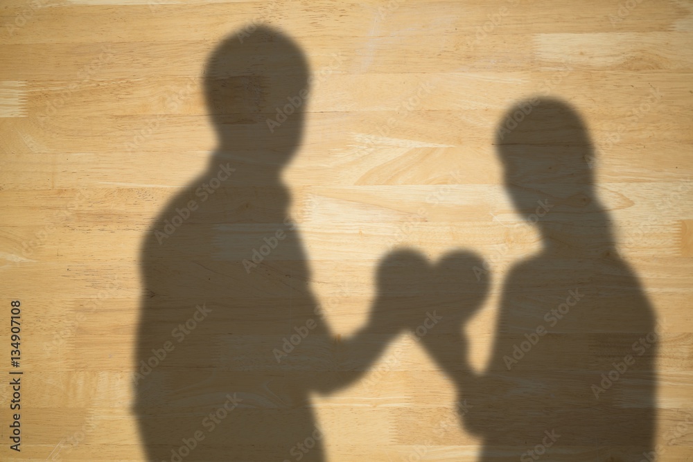 Composite image of couple holding a red heart