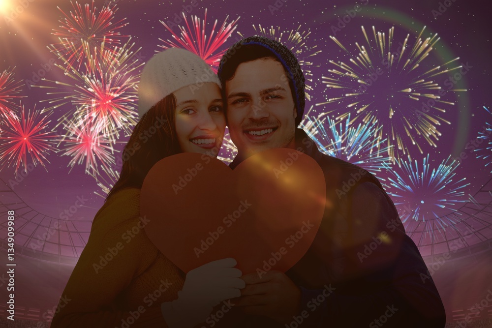 Composite image of portarit of happy couple holding paper heart