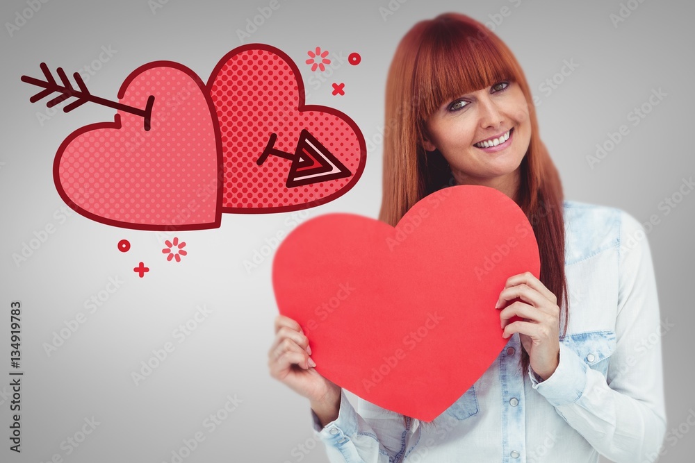 Composite image of attractive hipster woman behind a red heart