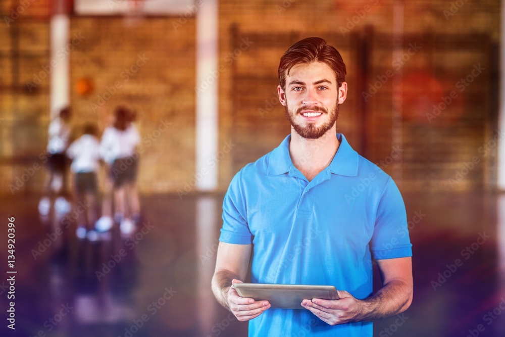 Portrait of sports teacher using digital tablet