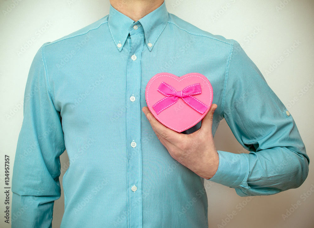 man holding a gift box in the form of heart 