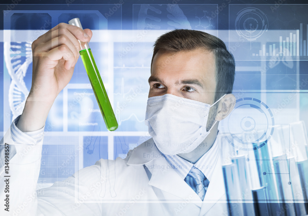 Portrait of concentrated male scientist working with reagents in laboratory