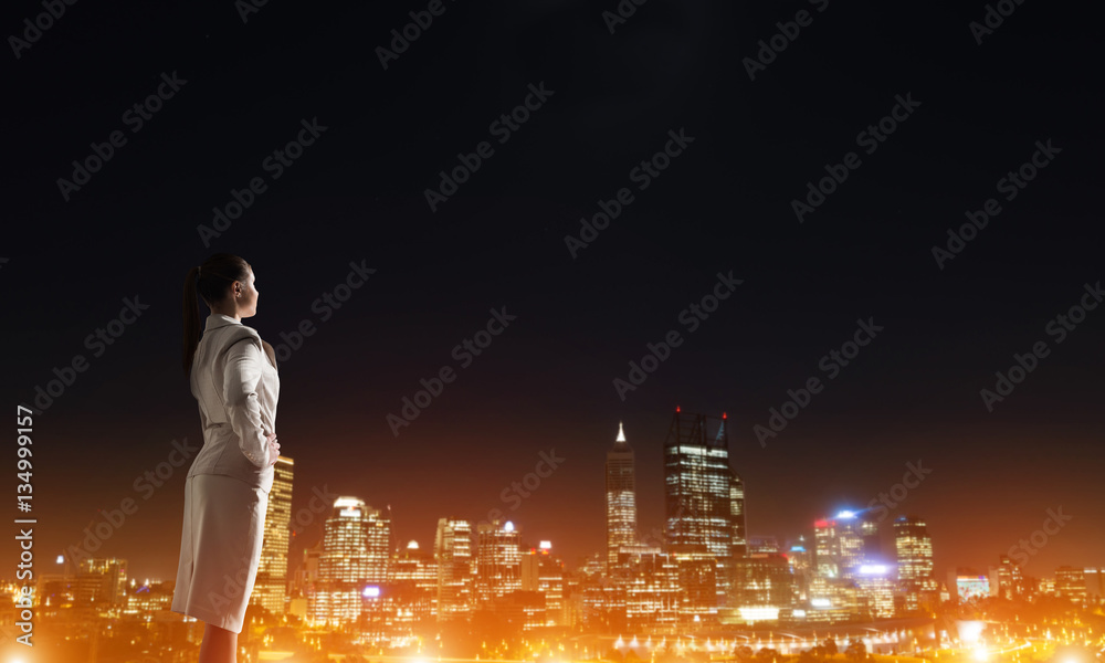 Woman looking at night city