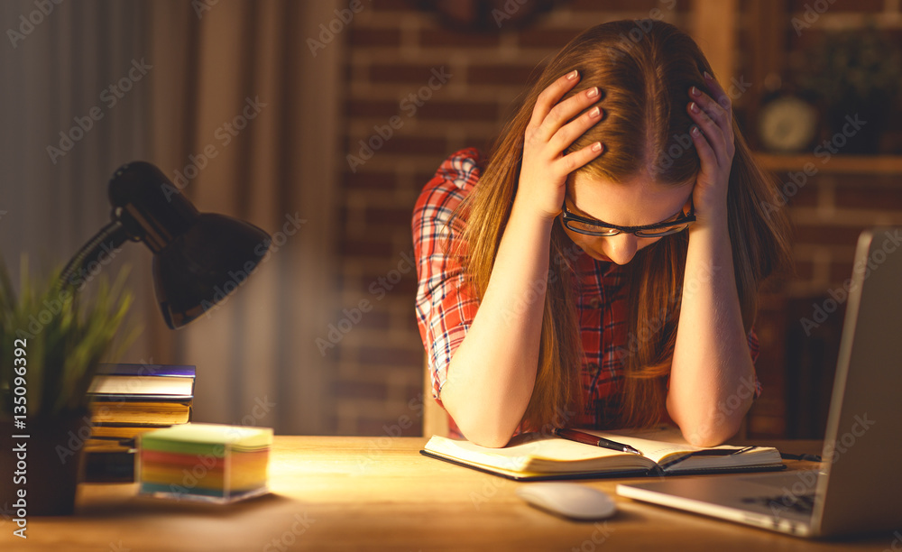 Woman under stress working at computer