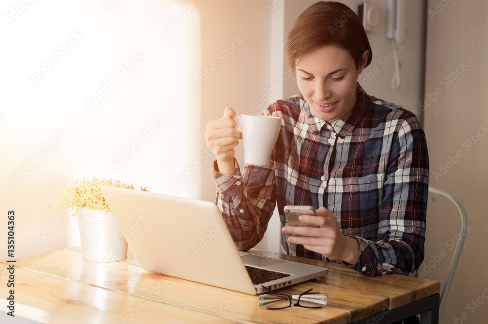 Portrait of young beautiful casual woman holding smartphone