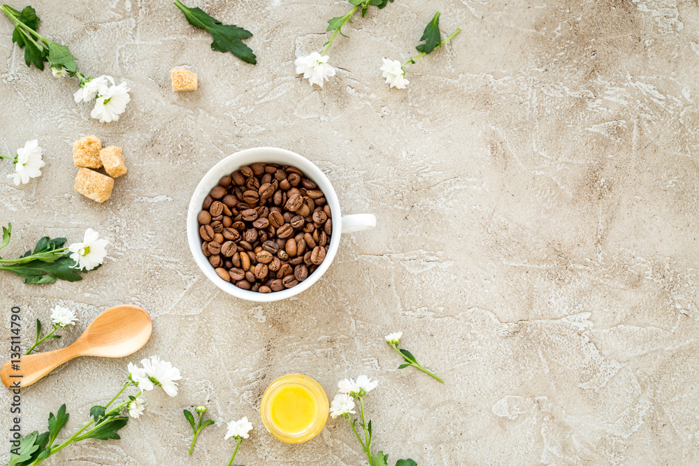 coffee beans on gray with coffe cup table top view