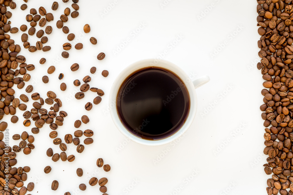 coffee beans on gray with coffe cup table top view