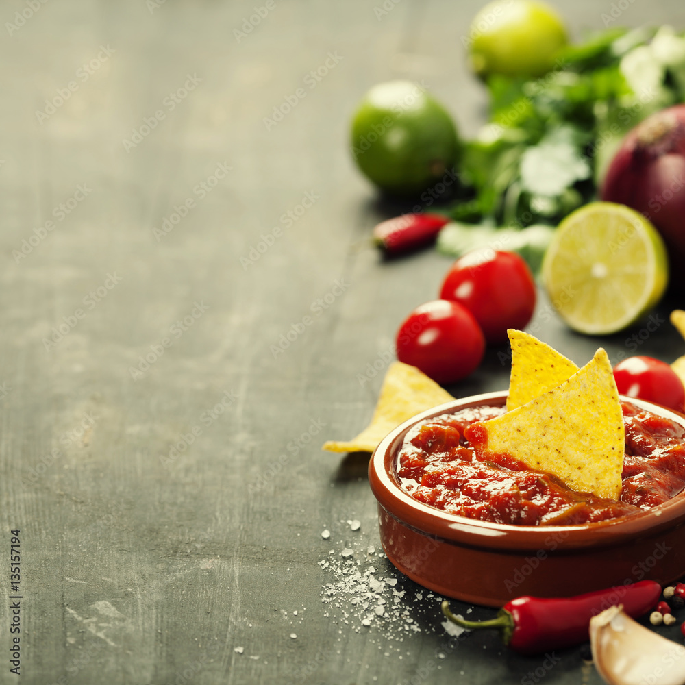 Fresh salsa dips with nachos chips on old background